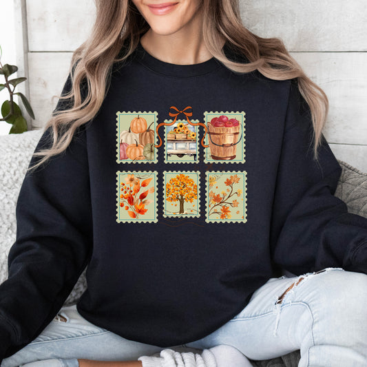 Person wearing a black sweatshirt with autumn-themed design including fall themed postage stamps