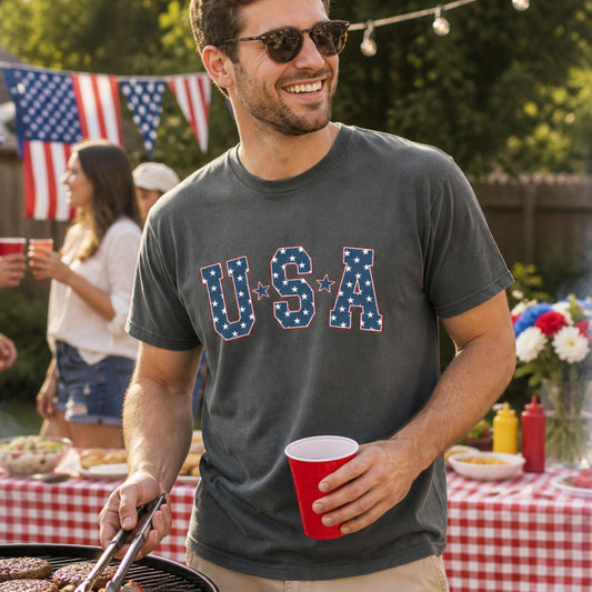 Man at a barbeque wearing a USA shirt.
