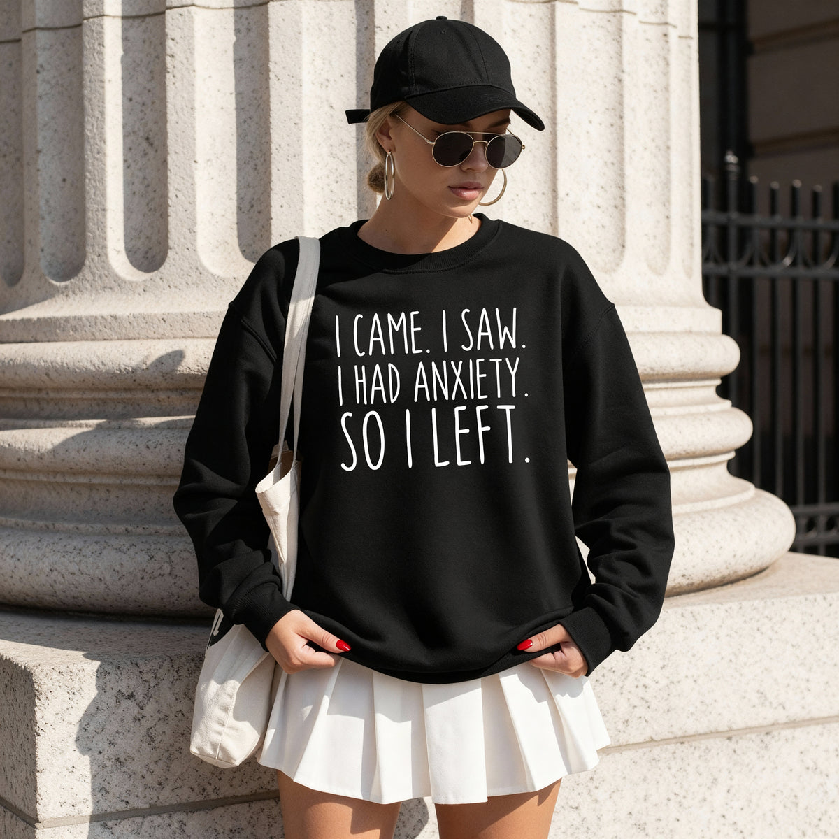 A woman wearing a black sweatshirt that says 'I Came I Saw I Had Anxiety So I Left.'