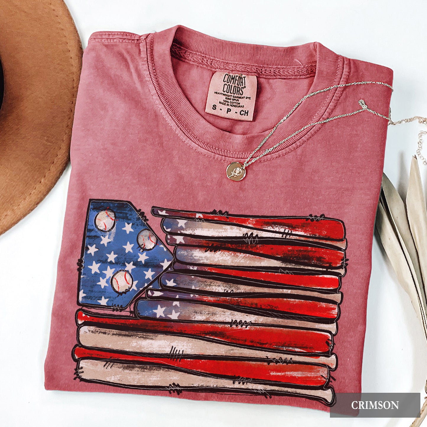 Woman wearing an american flag t-shirt that's made out of baseball bats and baseballs
