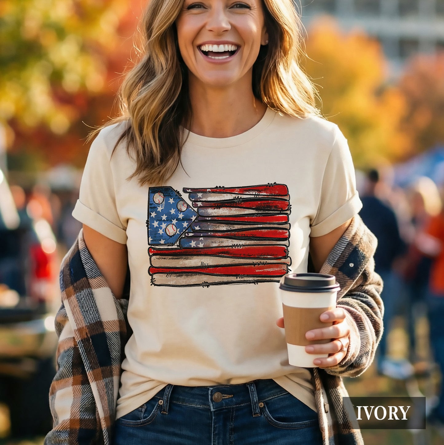 Woman wearing an american flag t-shirt that's made out of baseball bats and baseballs
