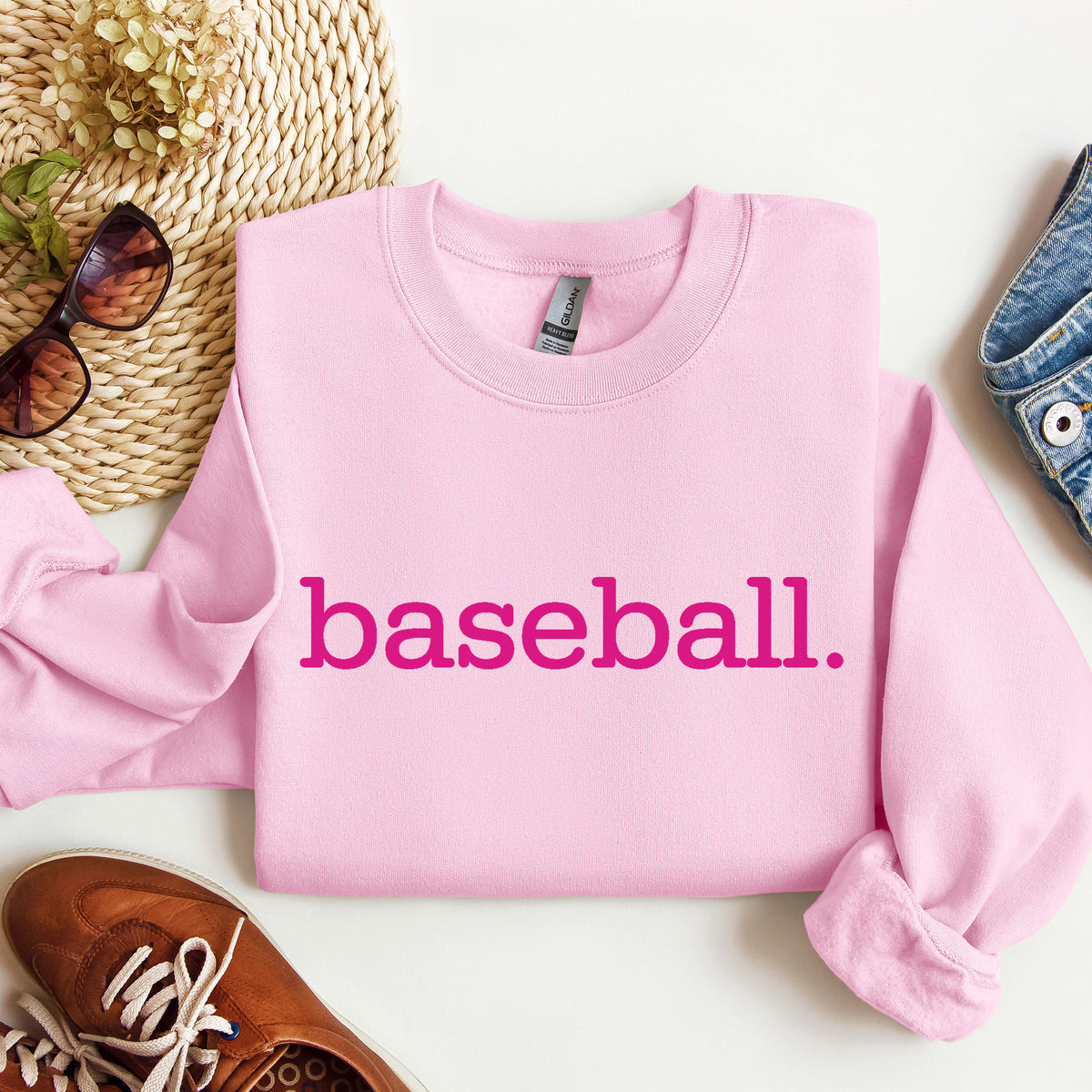 A light pink sweatshirt with 'baseball.' on it in hot pink print.