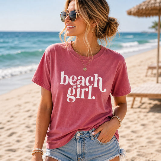 Woman wearing a 'beach girl' t-shirt on a beach