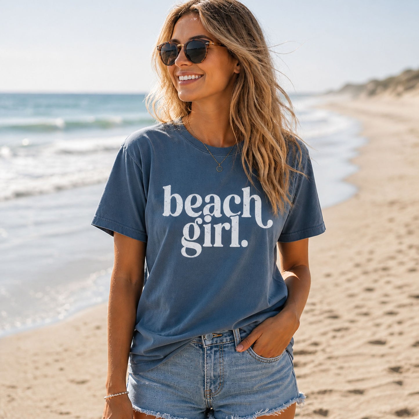 Woman wearing a 'beach girl' t-shirt on a beach
