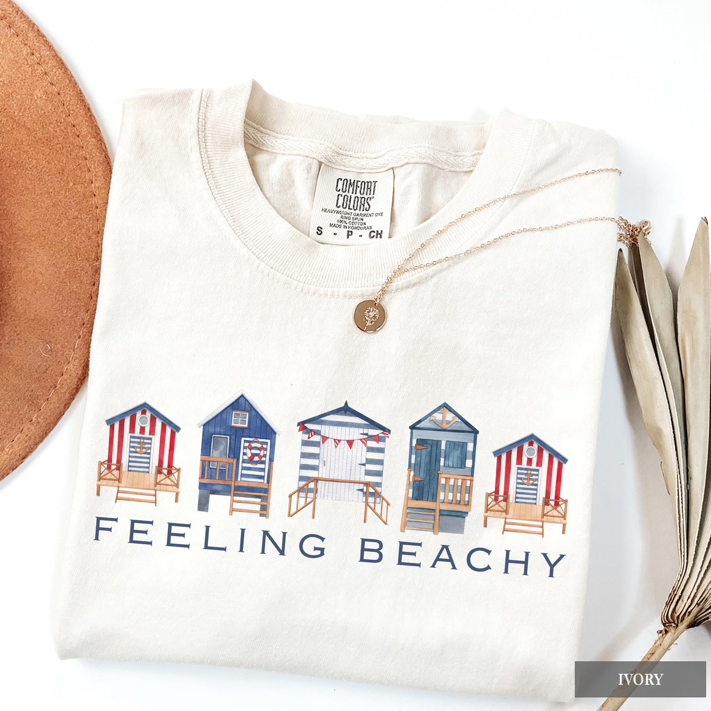 White sweatshirt with beach hut design and 'Feeling Beachy' text on a white background