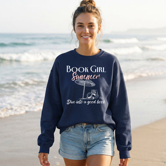 Woman wearing a navy sweatshirt with 'Book Girl Summer' text on a beach.
