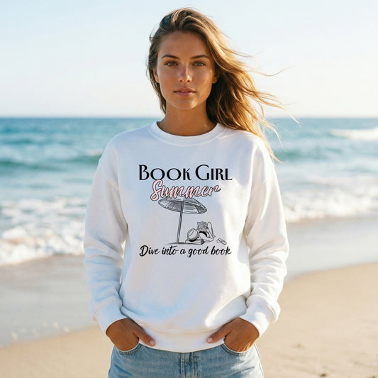 Woman wearing a 'Book Girl Summer' sweatshirt on a beach