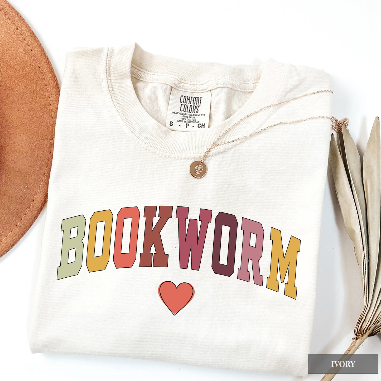 White sweatshirt with 'BOOKWORM' text and a heart on a white background