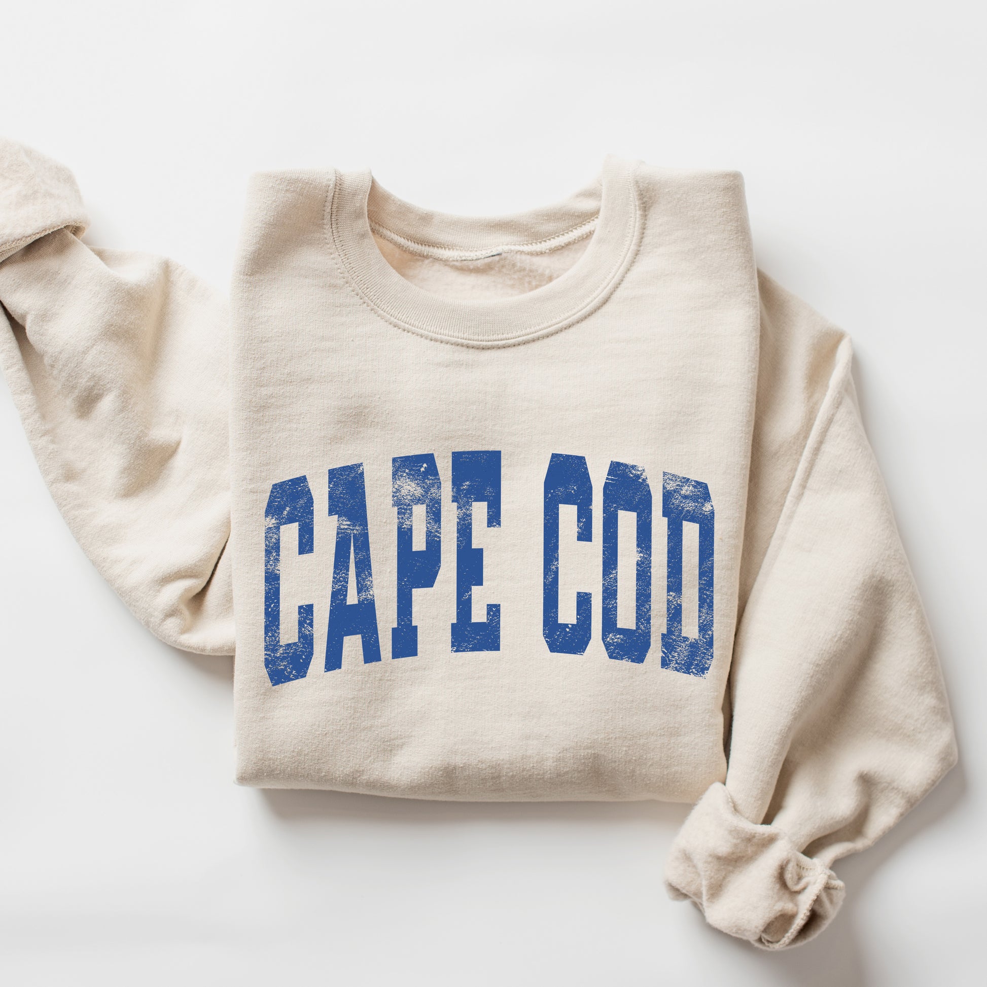 Beige sweatshirt with 'CAPE COD' printed in blue on a white background