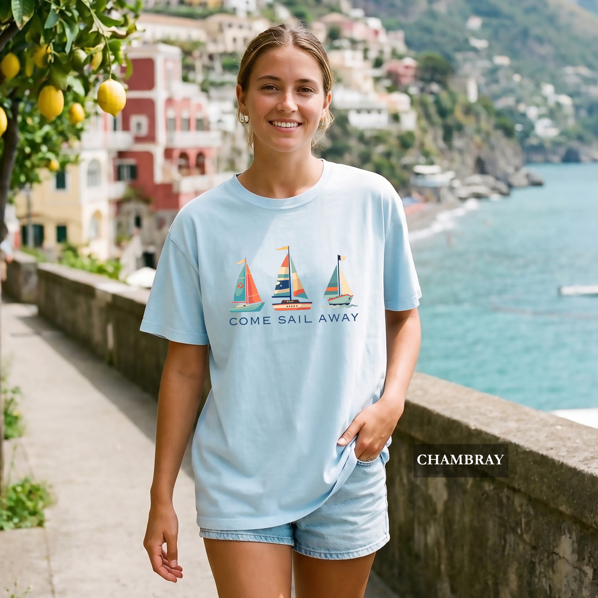 Woman wearing a chambray t-shirt with coastal scenery in the background