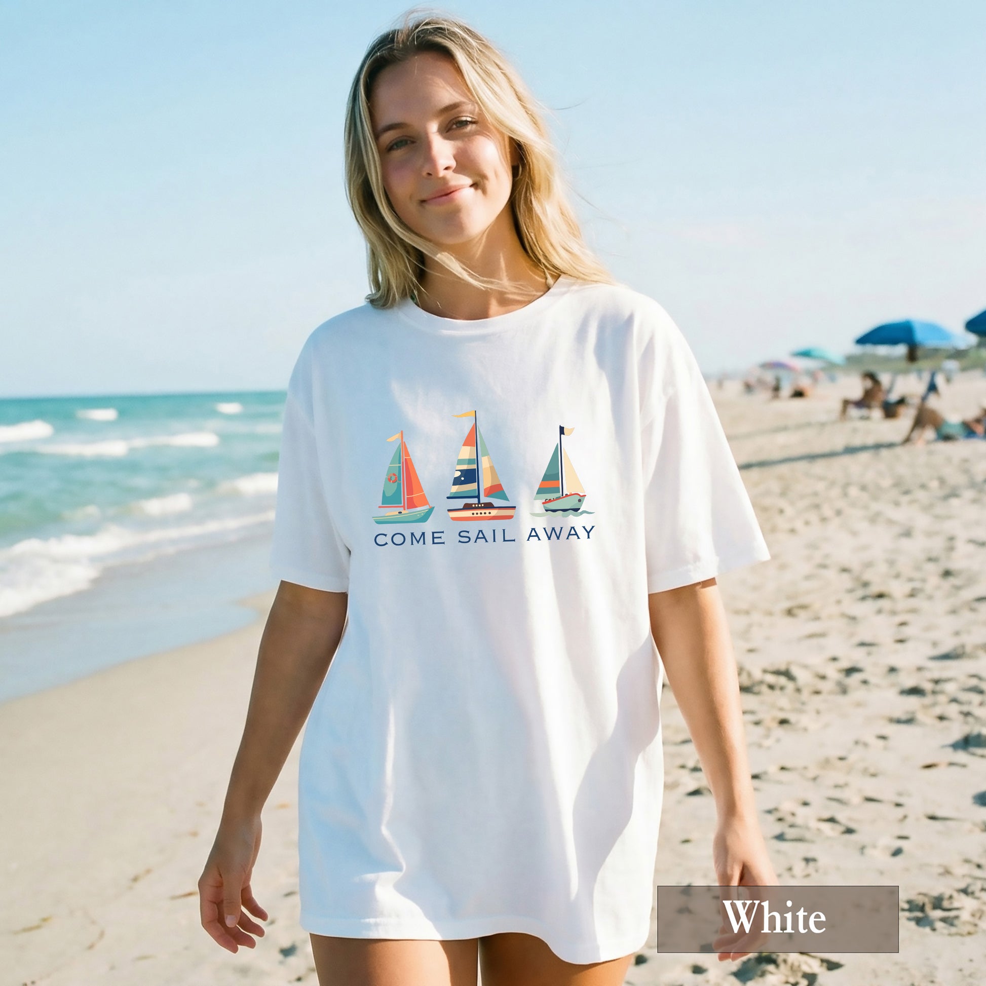 Woman wearing a white t-shirt with sailboat design on a beach