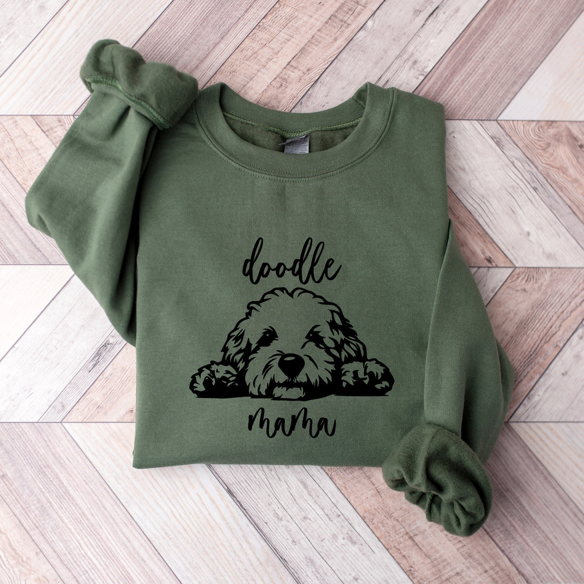 A military green sweatshirt with 'doodle mama' and a picture of a goldendoodle on it.