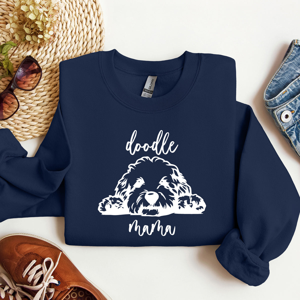 A navy sweatshirt with 'doodle mama' and a picture of a goldendoodle on it.