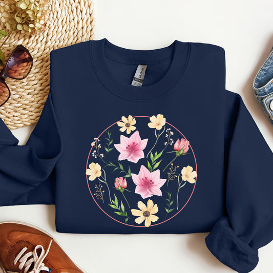 Navy blue sweatshirt with floral design on a white surface with accessories.