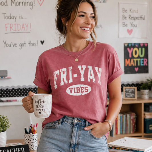 Person wearing a 'FRI-YAY VIBES' t-shirt in a classroom setting