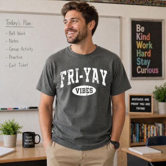 Man wearing a 'FRI-YAY VIBES' t-shirt in a classroom setting