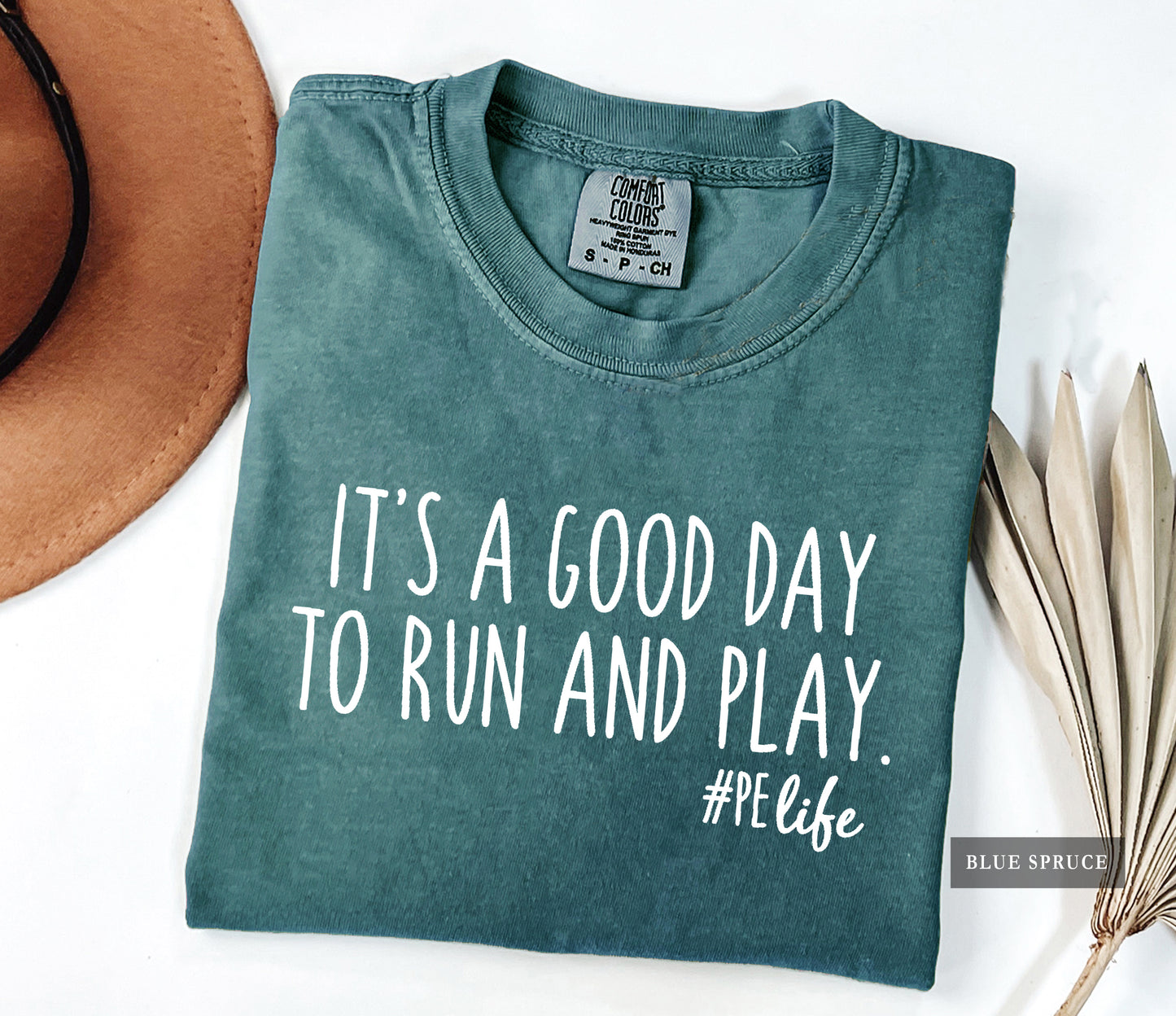 A blue spruce comfort colors shirt that says It's a Good Day to Run and Play #PE life