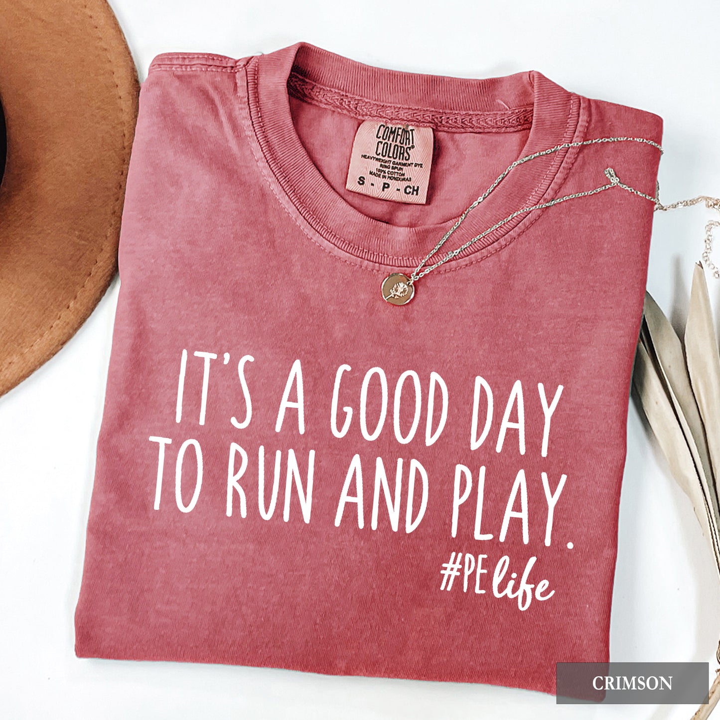 A crimson comfort colors shirt that says It's a Good Day to Run and Play #PE life