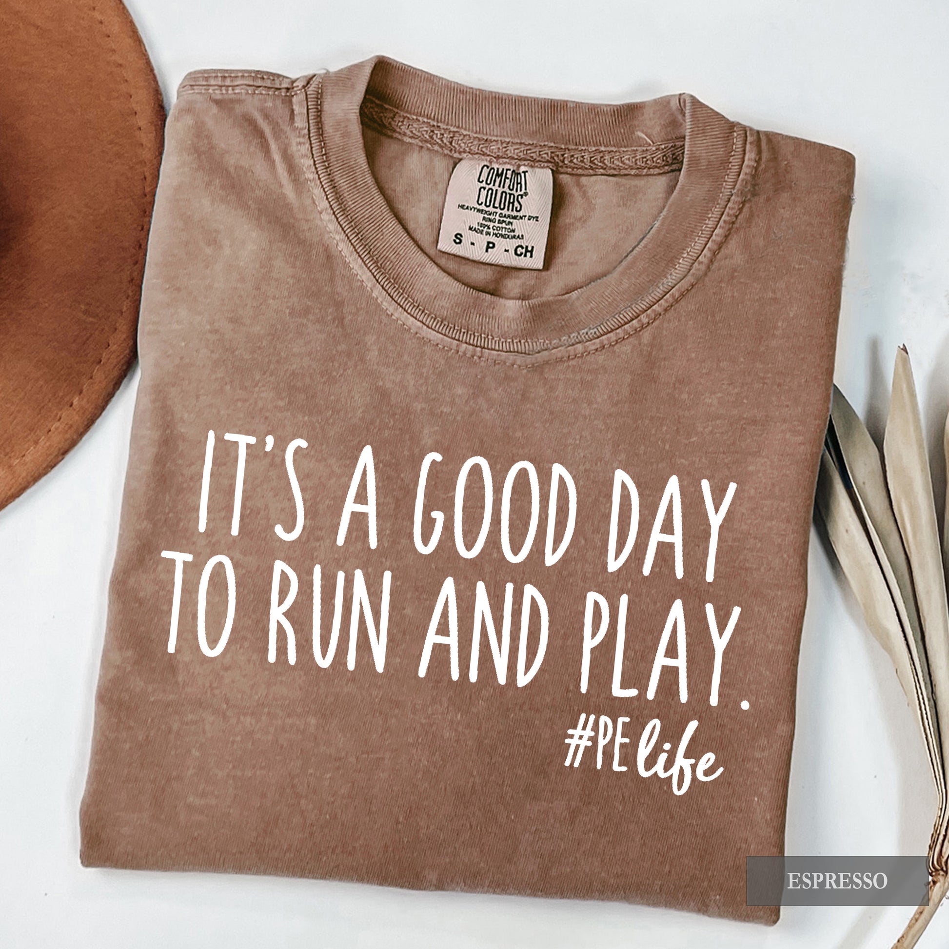 An espresso comfort colors shirt that says It's a Good Day to Run and Play #PE life