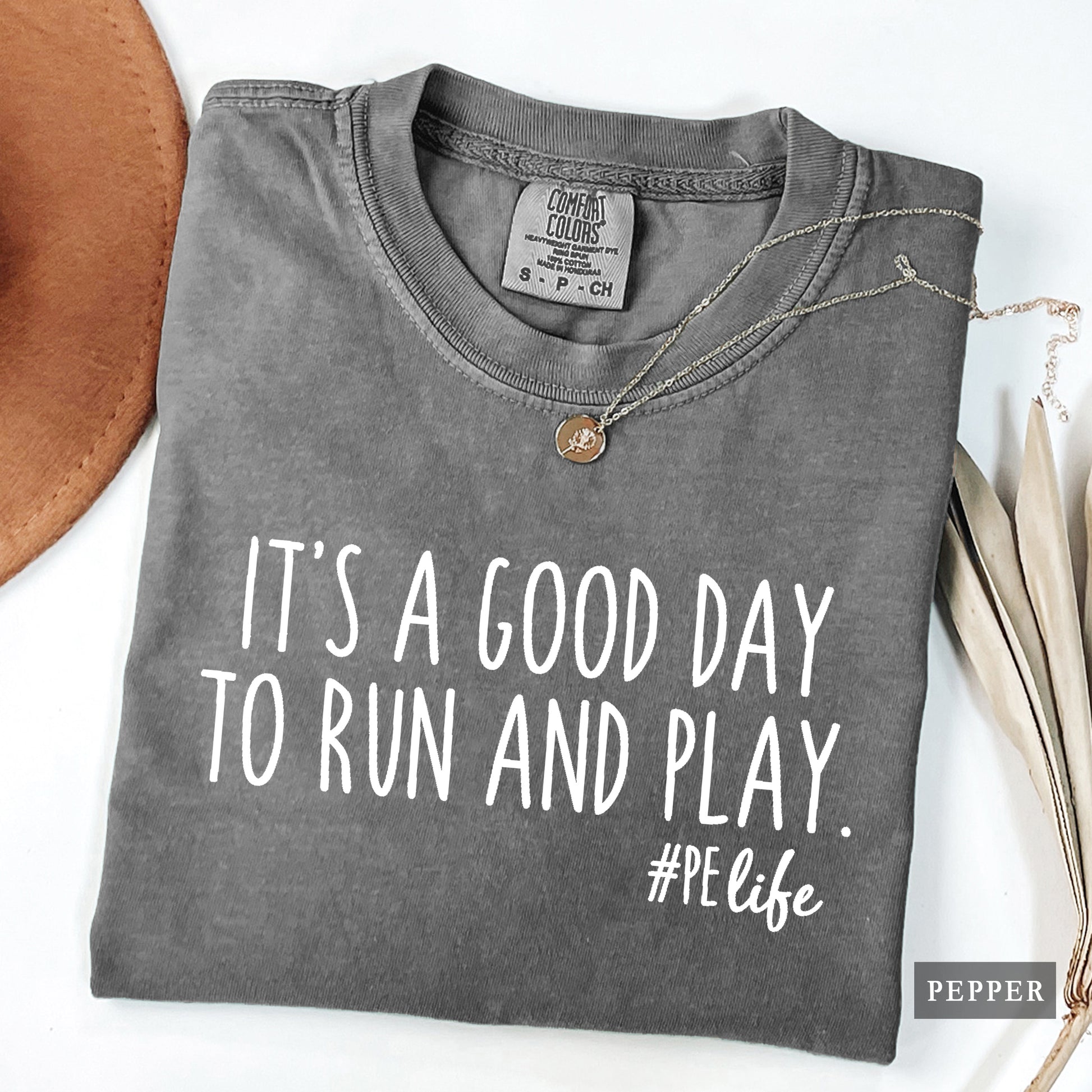 A pepper comfort colors shirt that says It's a Good Day to Run and Play #PE life