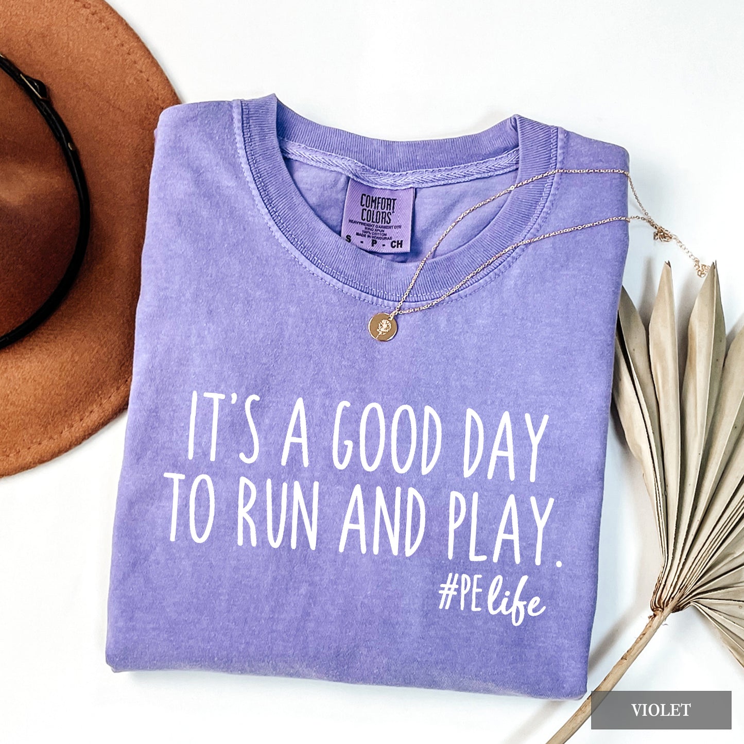 A violet comfort colors shirt that says It's a Good Day to Run and Play #PE life