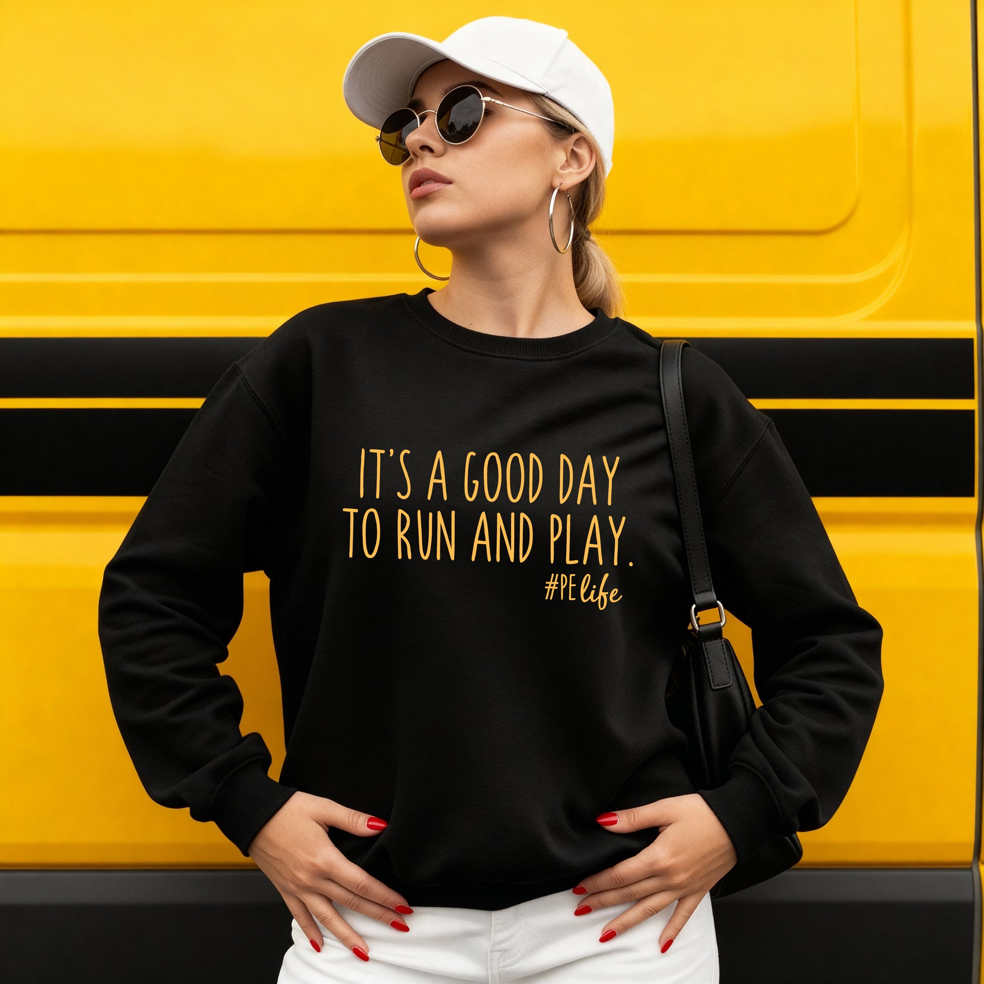 Woman wearing a black Gildan sweatshirt that says It's a Good Day to Run and Play #PE life