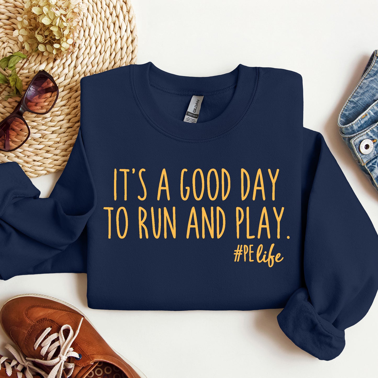 A navy Gildan sweatshirt that says It's a Good Day to Run and Play #PE life