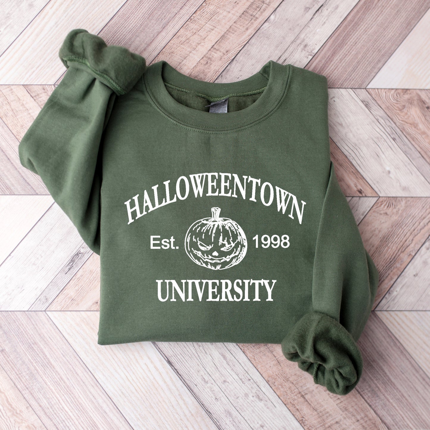 A military green Gildan sweatshirt that says Halloweentown University Ets. 1998 and has a scary jack-o-lantern on it.