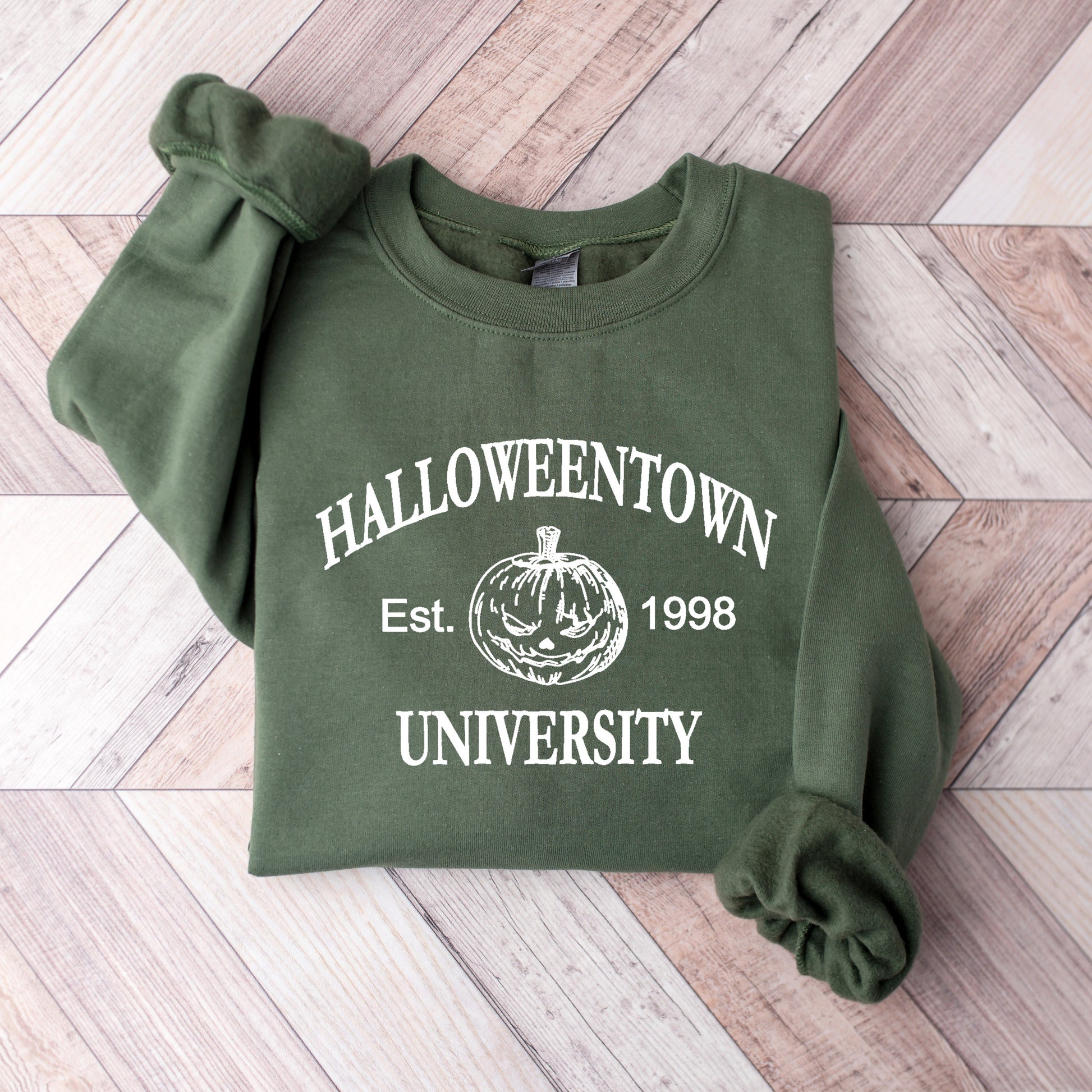 A military green Gildan sweatshirt that says Halloweentown University Ets. 1998 and has a scary jack-o-lantern on it.