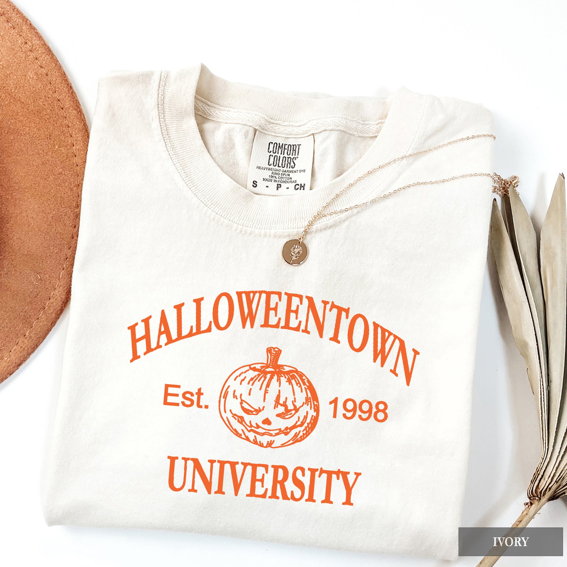 An ivory comfort colors shirt that says Halloweentown University.