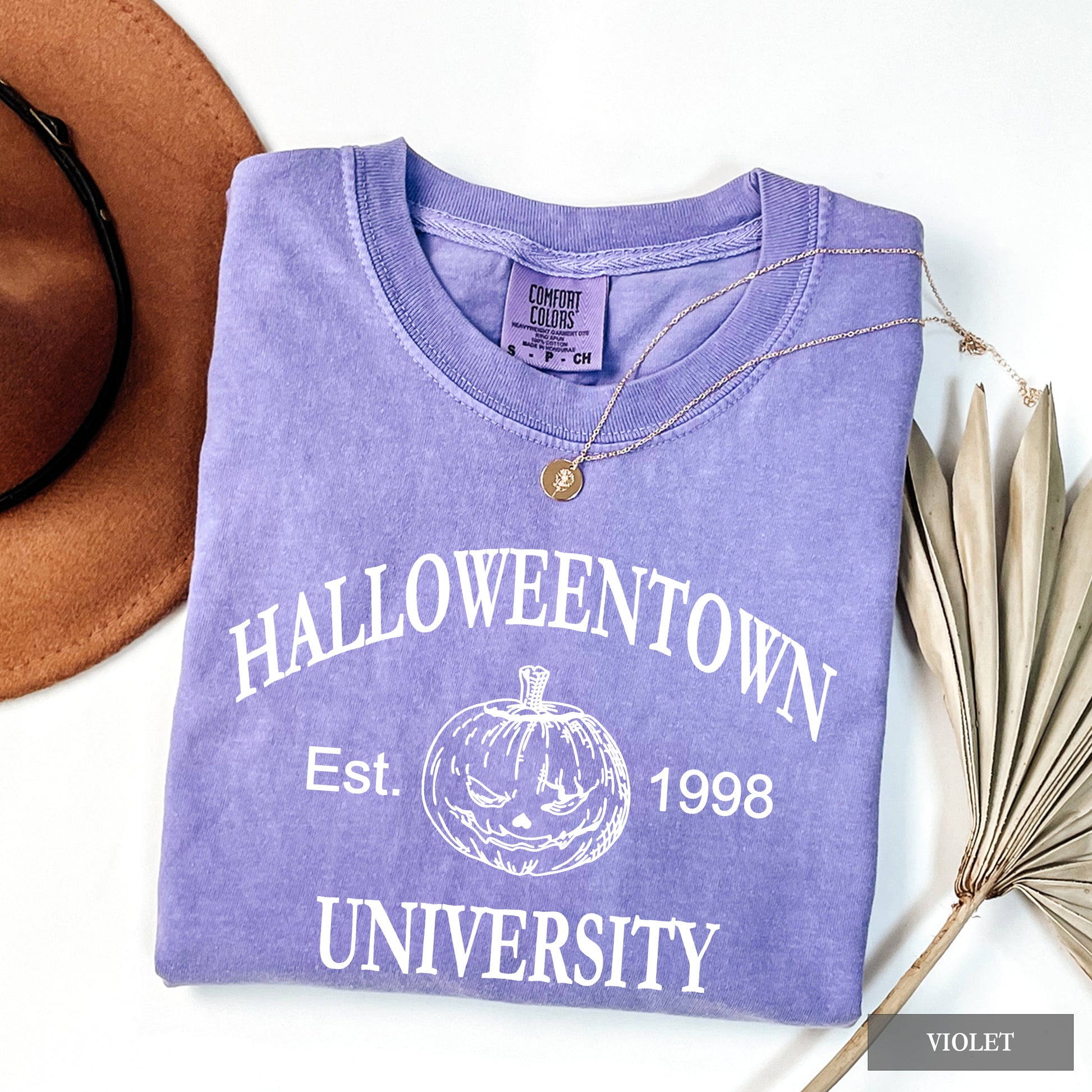 A Violet comfort colors shirt that says Halloweentown University.