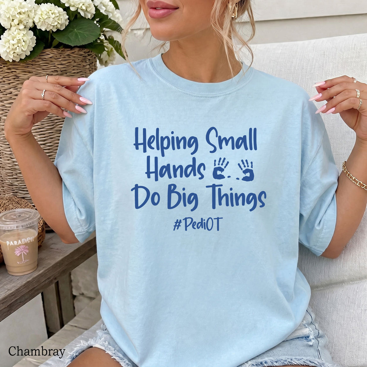 A woman wearing a chambray comfort colors shirt that says Helping Small Hands Do Big Things #PediOT