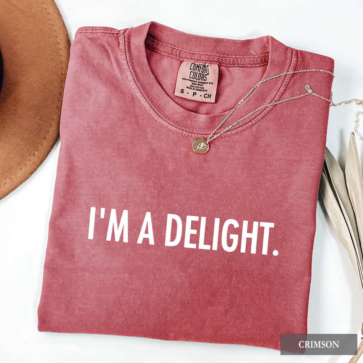 A crimson comfort colors shirt with 'I'm a Delight' on it in white print.