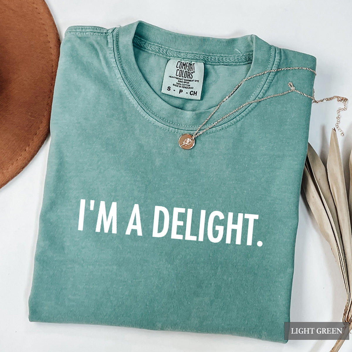 A light green comfort colors shirt with 'I'm a Delight' on it in white print.