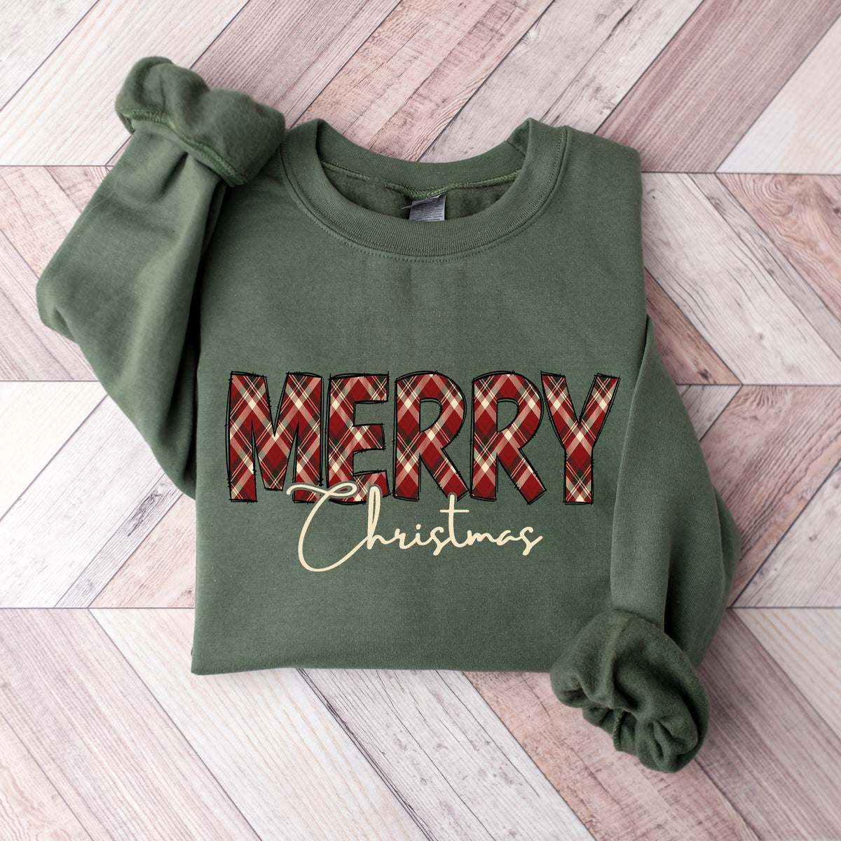 A military green Gildan sweatshirt with Merry in plaid and Christmas below that in script font.
