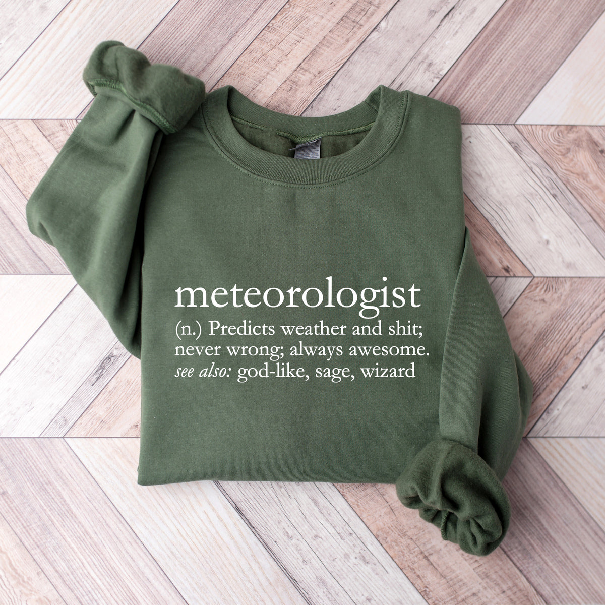 A military green crewneck sweatshirt that says 'meteorologist (n.) Predicts weather and shit; never wrong; always awesome. see also: god-like, sage, wizard