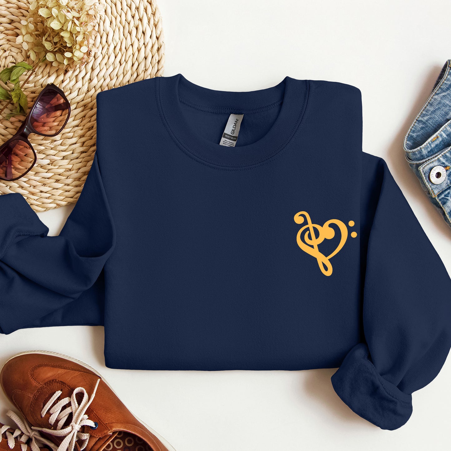 A navy  gildan sweatshirt with a musical note shaped like a heart on the pocket area.
