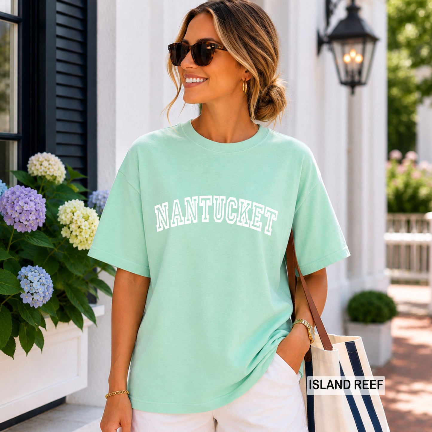 Woman wearing an island reef comfort colors shirt that says Nantucket.