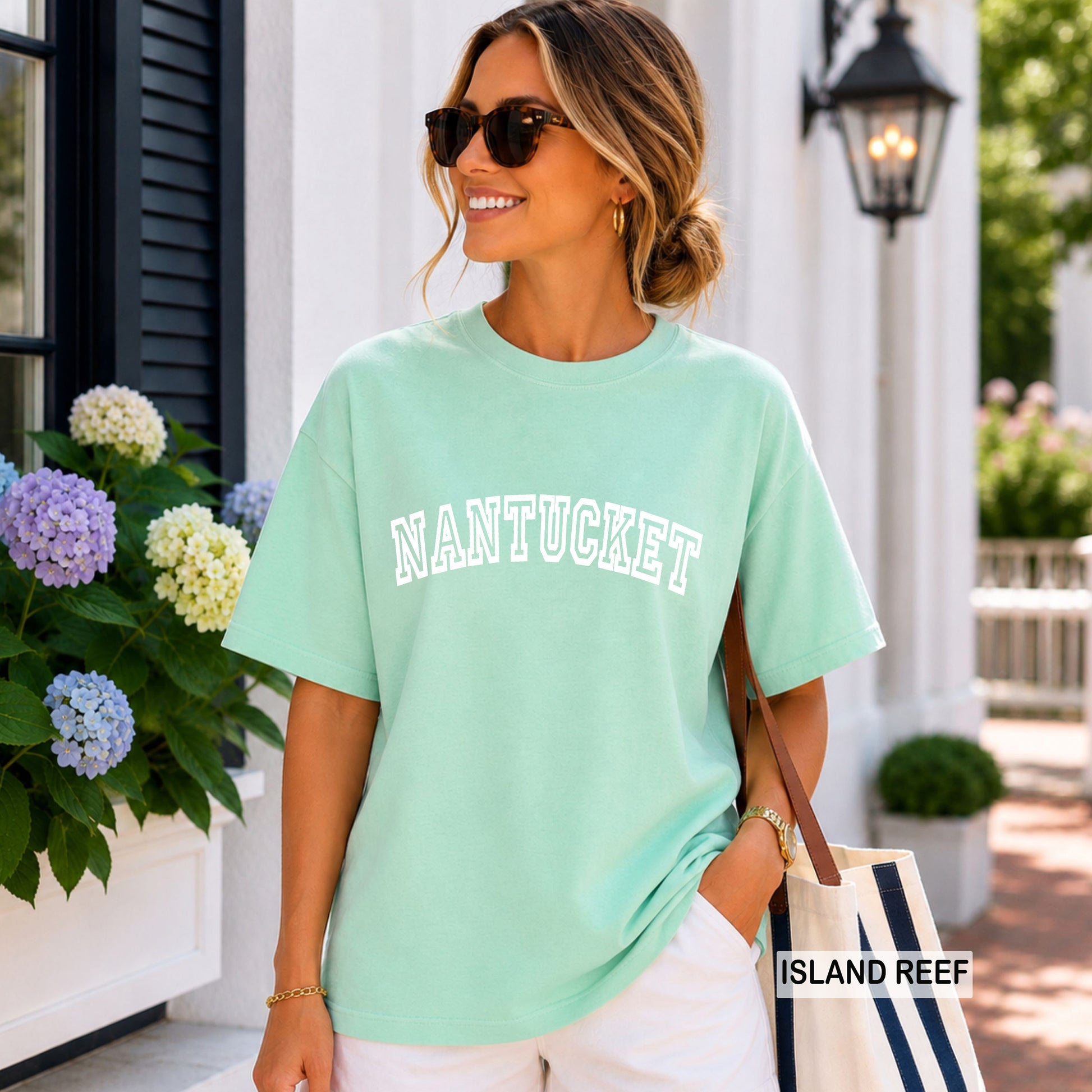 Woman wearing an island reef comfort colors shirt that says Nantucket.