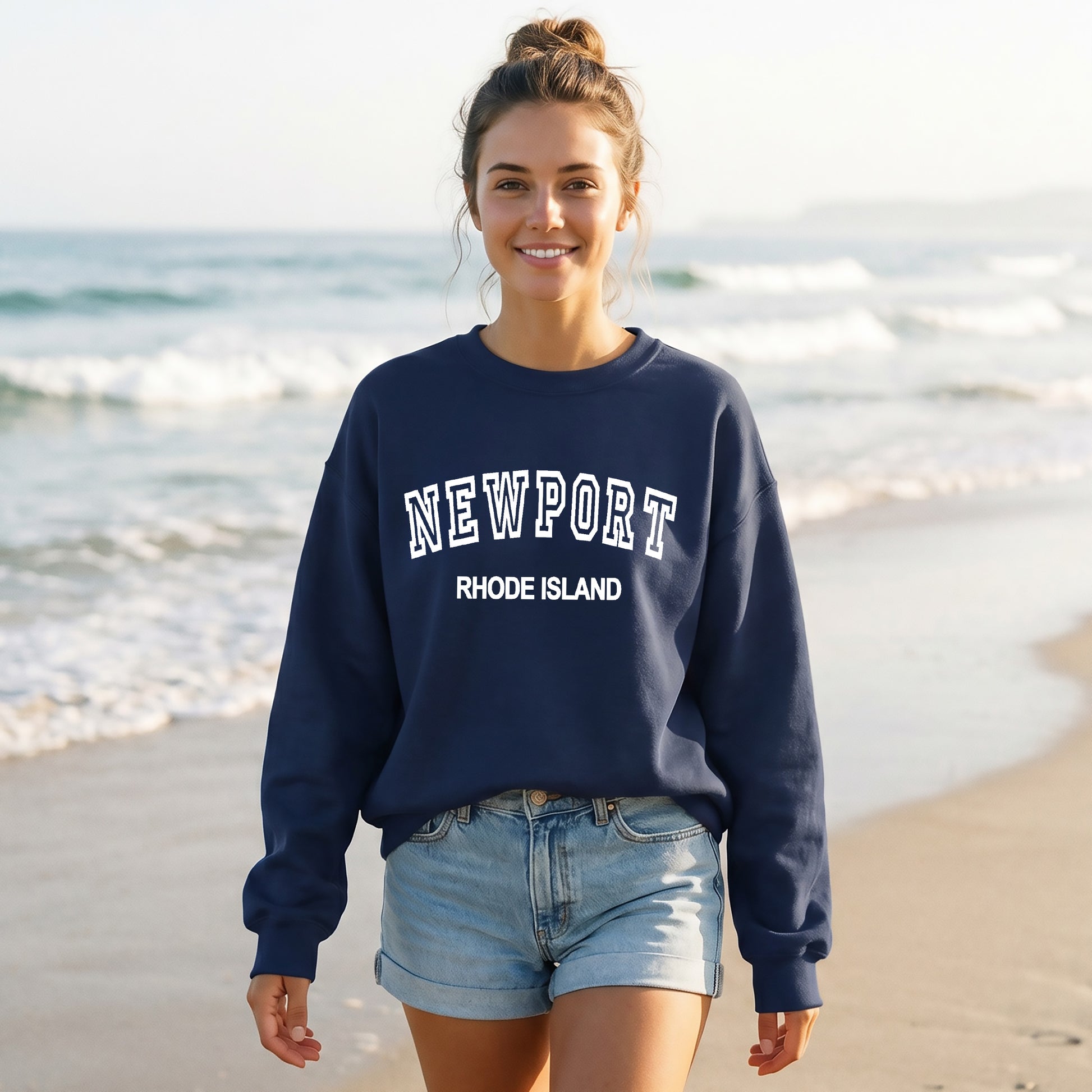 Woman wearing a navy sweatshirt with 'Newport Rhode Island' text on a beach.