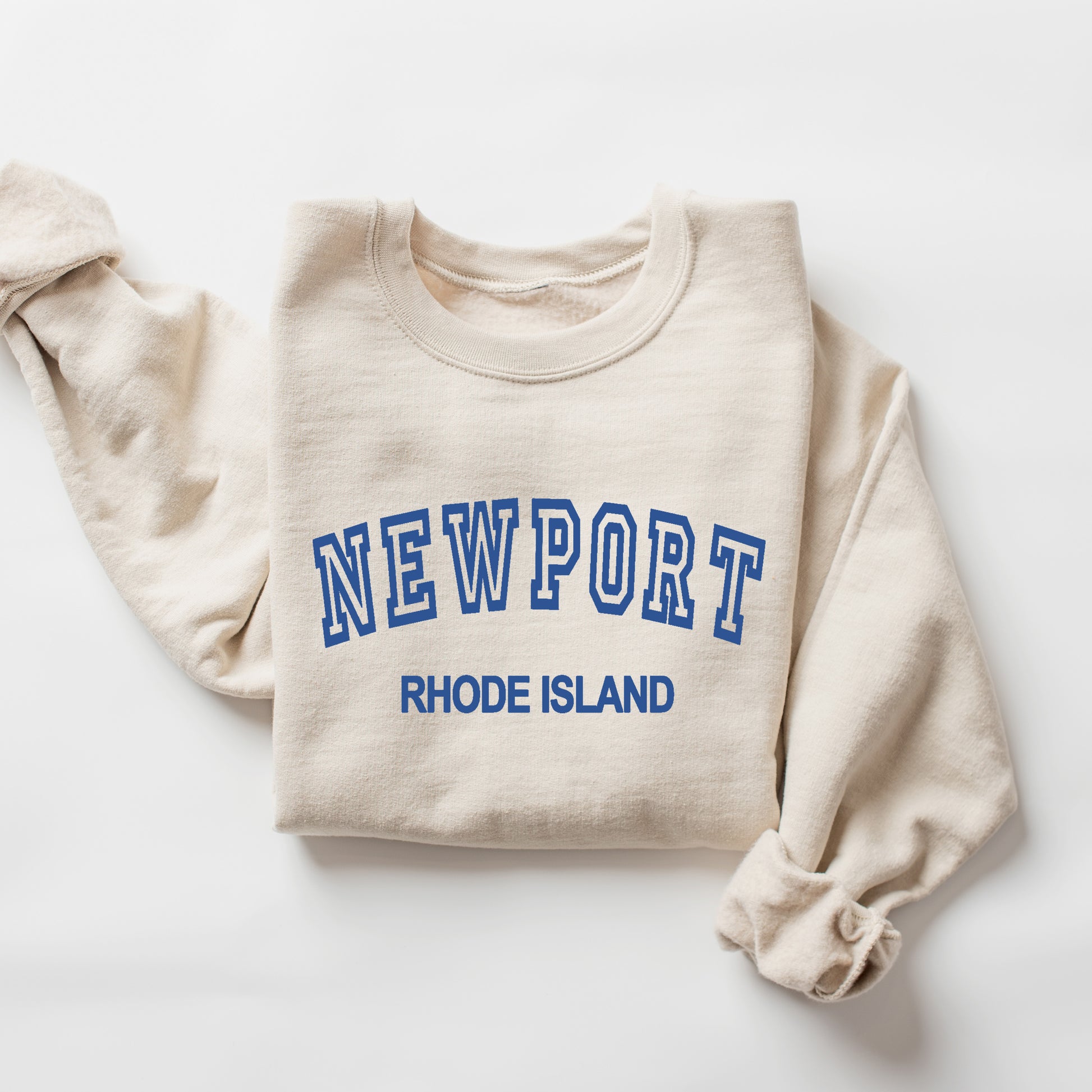 Beige sweatshirt with 'Newport Rhode Island' text in blue on a white background