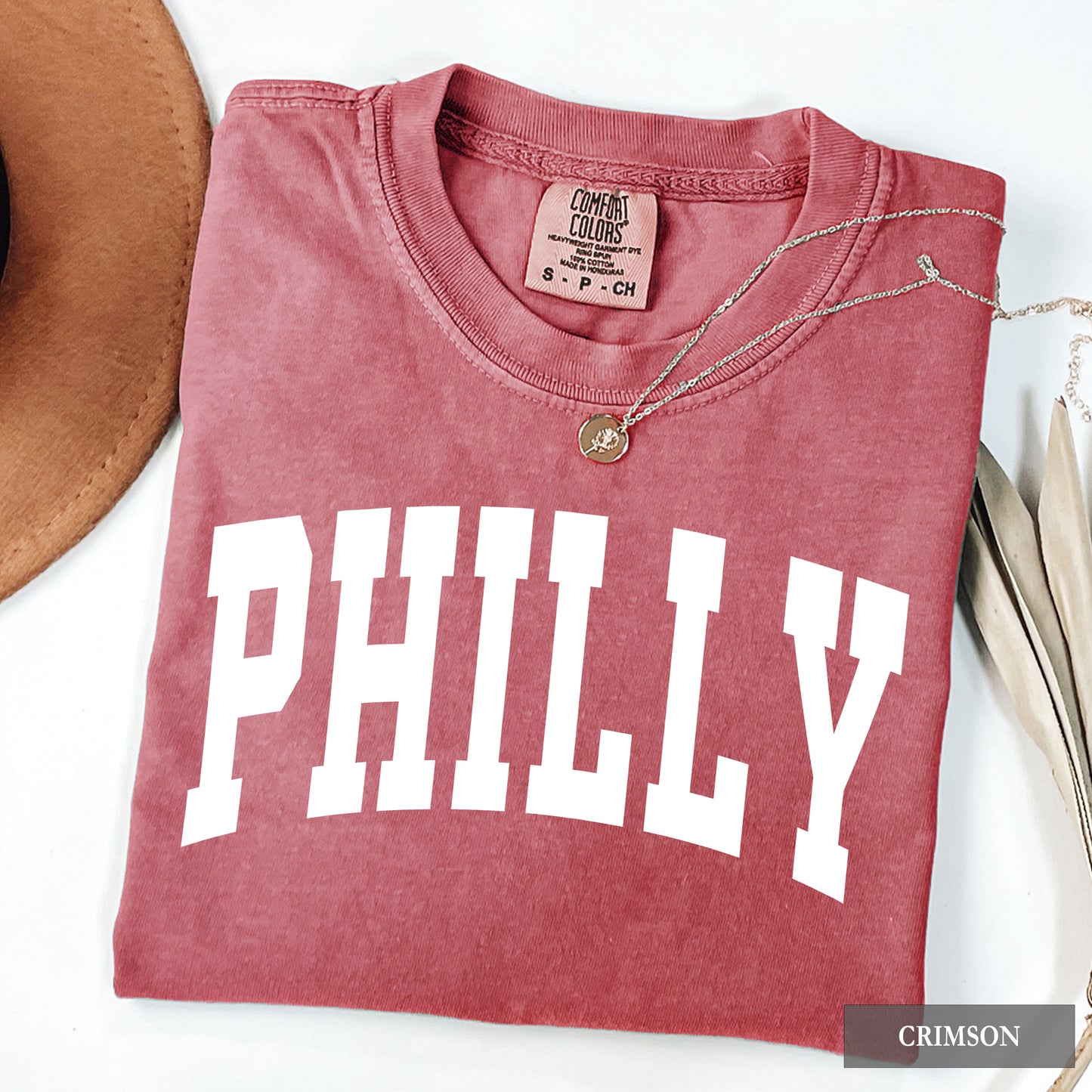 A crimson comfort colors t-shirt that says Philly on the front.