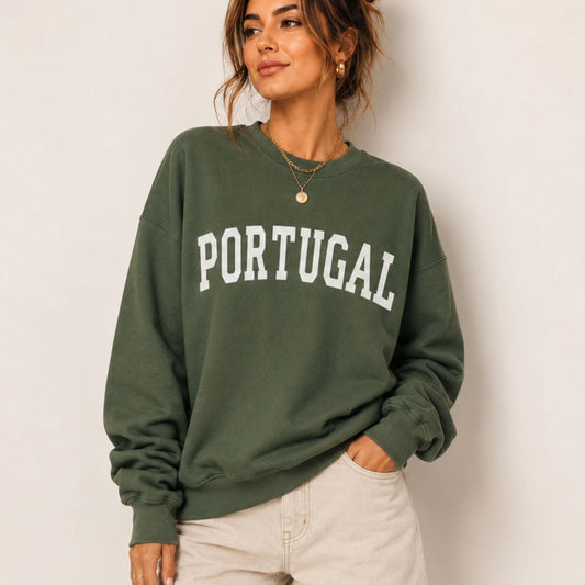 Woman wearing a green sweatshirt with 'PORTUGAL' text against a plain background