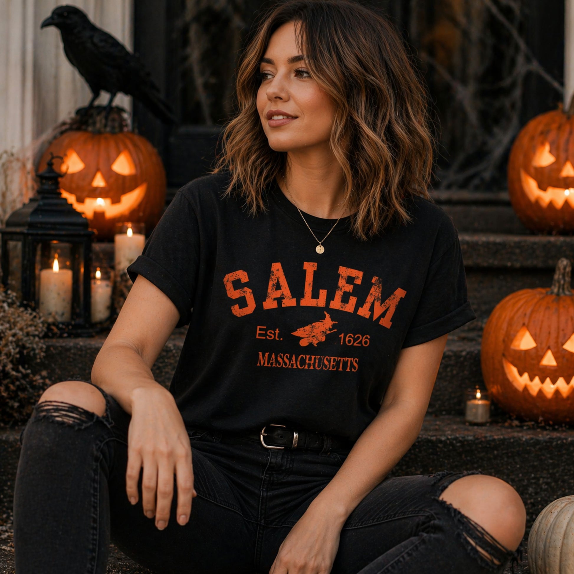 Woman wearing a 'Salem' t-shirt in front of Halloween-themed decorations.