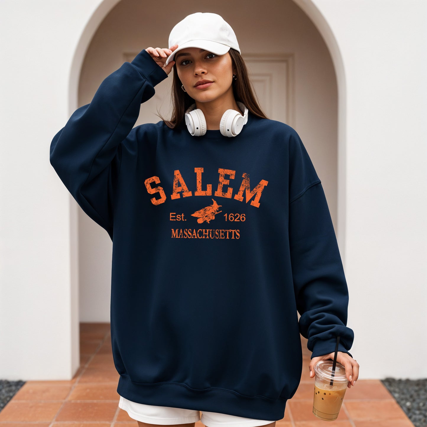 Person wearing a navy sweatshirt with 'Salem, Massachusetts' text and graphics.