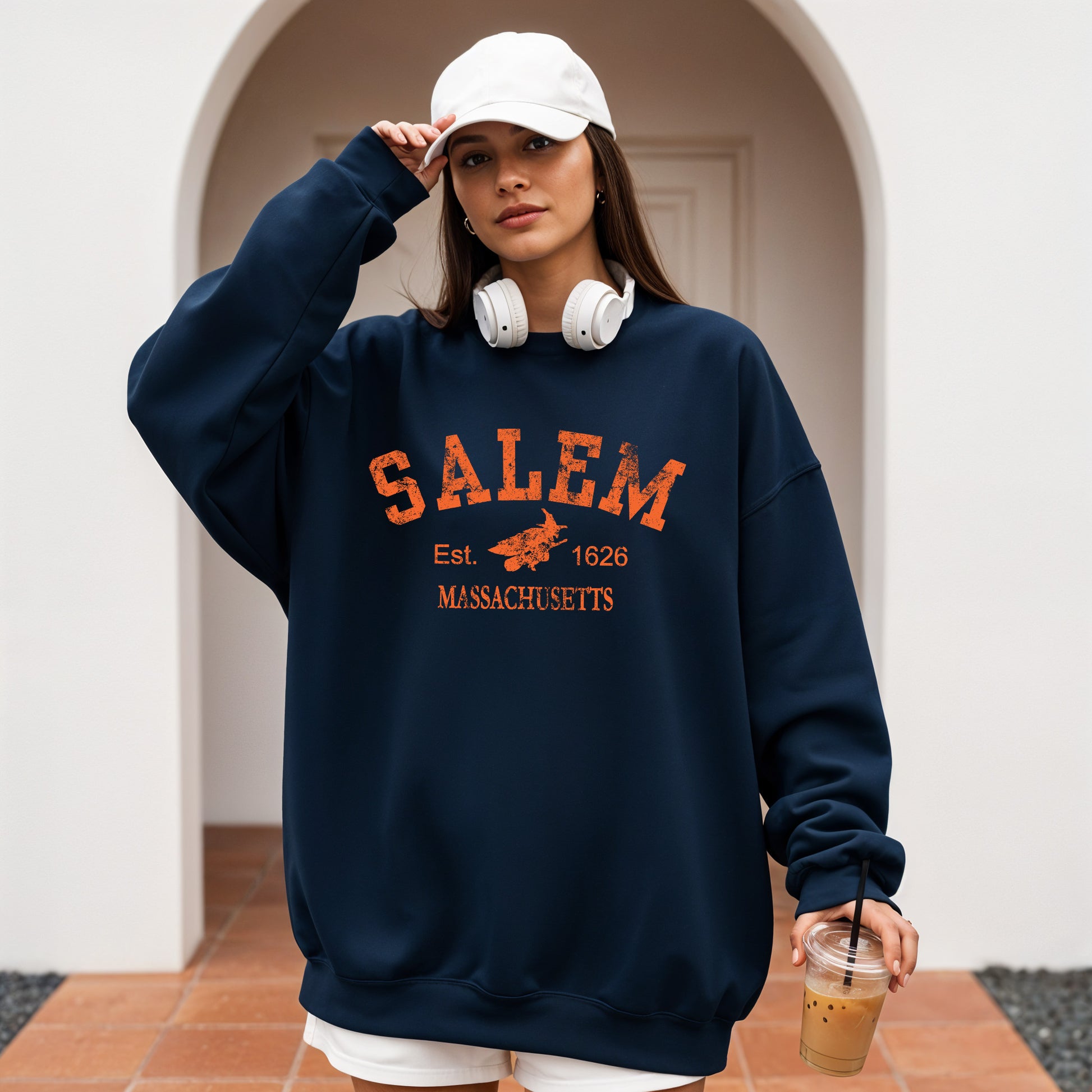 Person wearing a navy sweatshirt with 'Salem, Massachusetts' text and graphics.