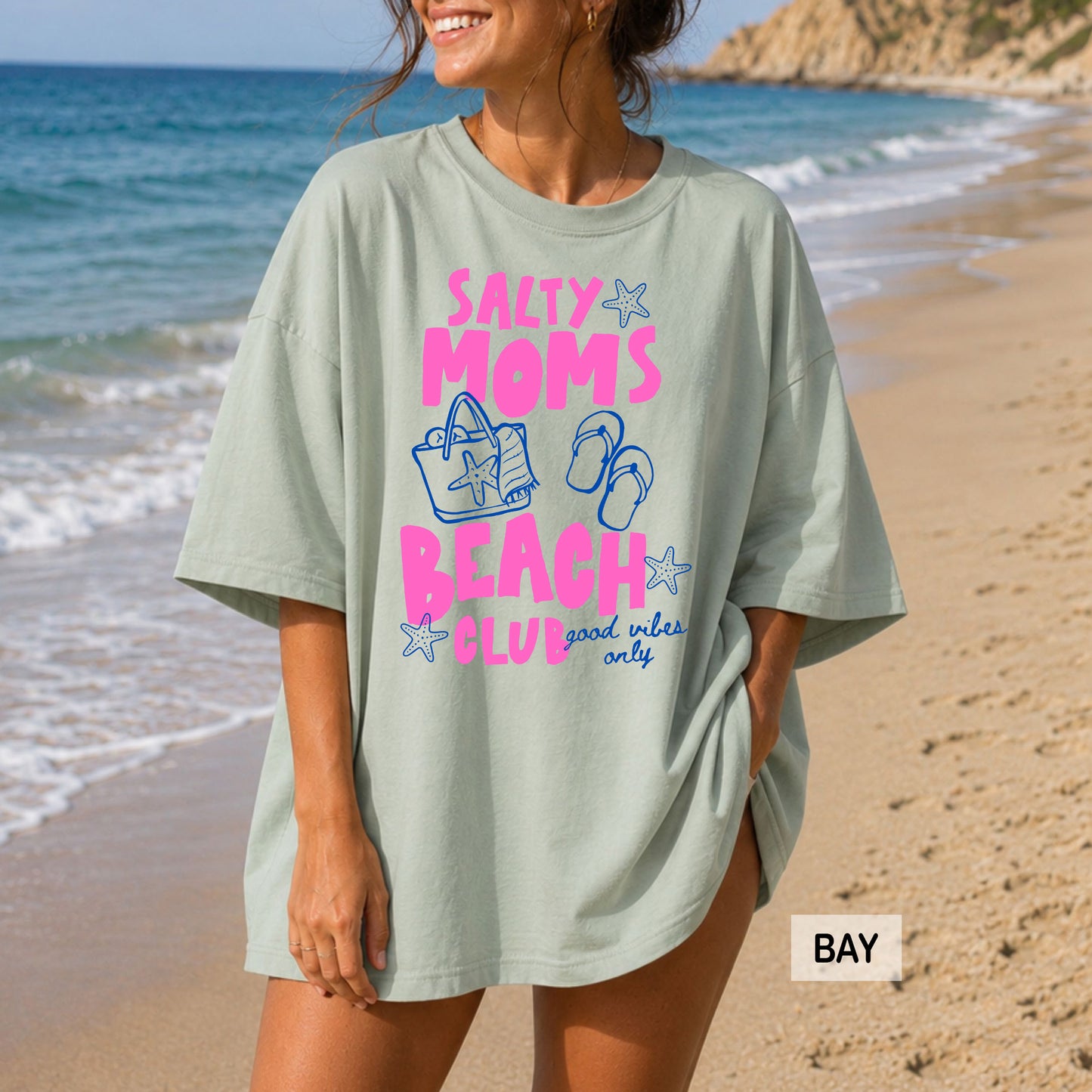 Woman wearing a 'Salty Moms Beach Club' shirt on a beach
