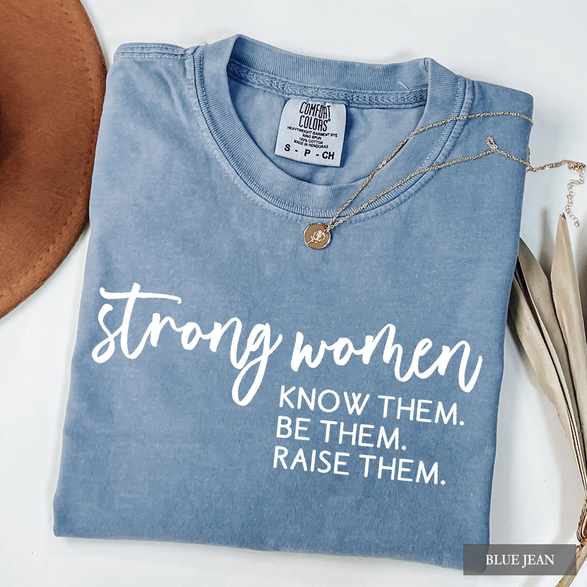 A blue jean comfort colors shirt that says 'Strong Women Know Them Be Them Raise Them.
