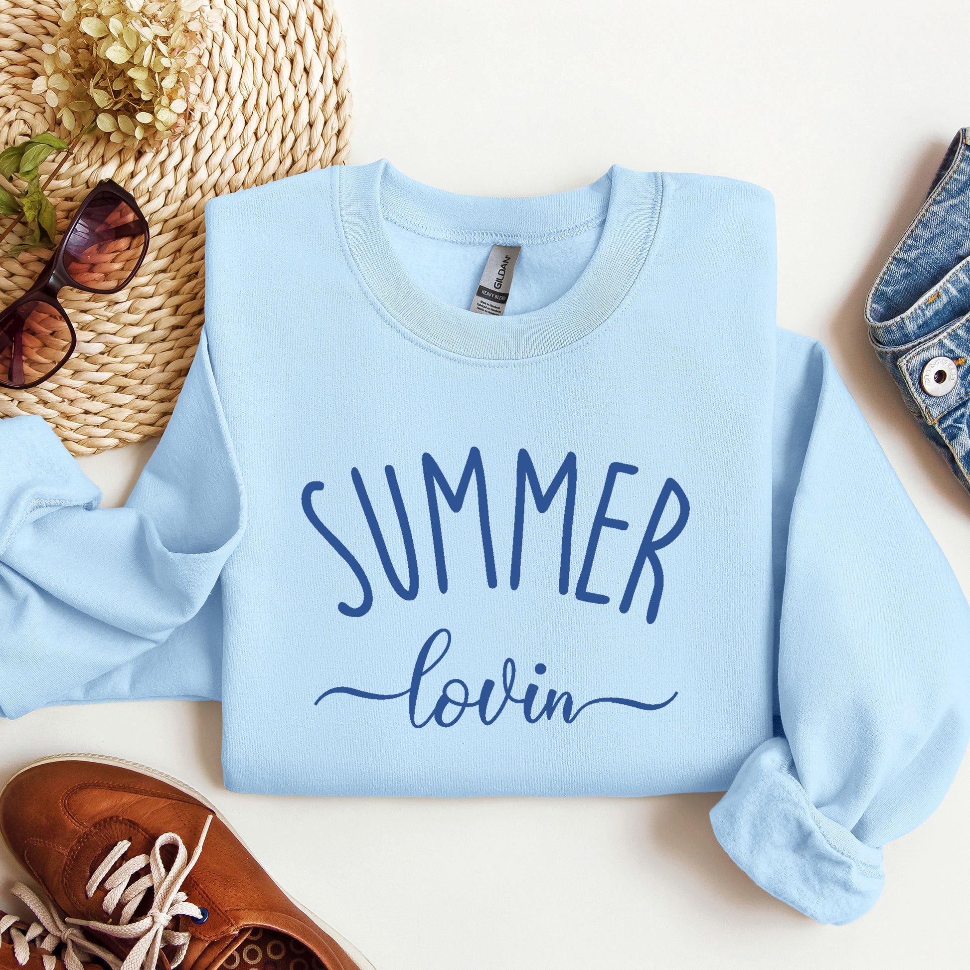 A light blue Gildan sweatshirt that says Summer Lovin on it.