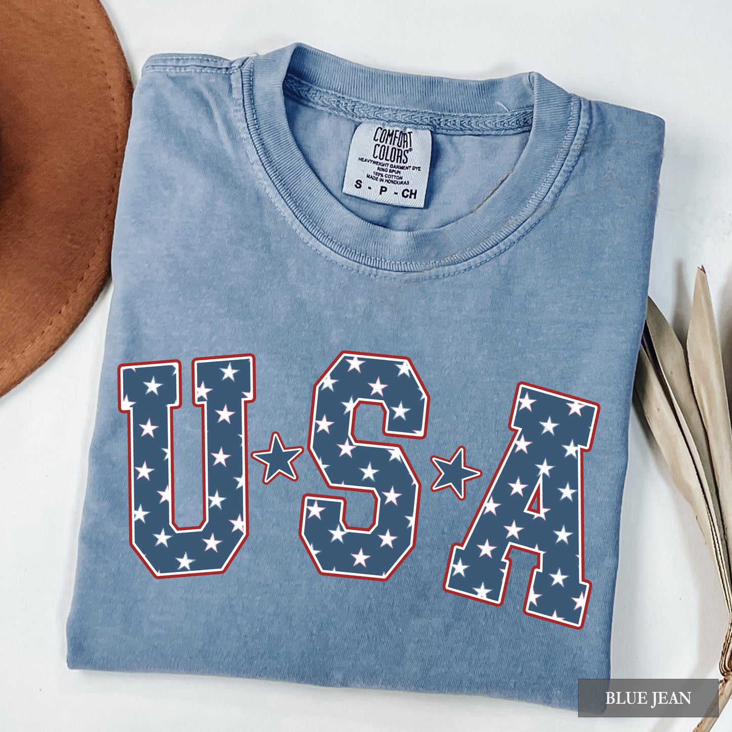 Blue t-shirt with 'USA' design on a white surface